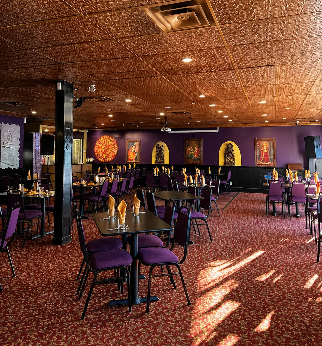 Booth seating and wall mural in the dining room at Charisma Of India, East Indian restaurant on Sherbrook Street in Winnipeg